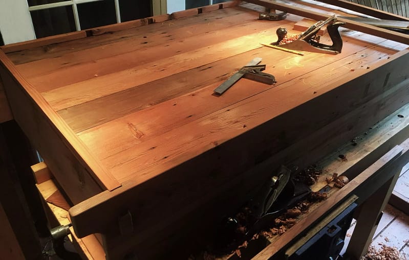 Back of a wooden credenza shown on a work bench in the shop of Marc Springer a woodworker in Los Angeles